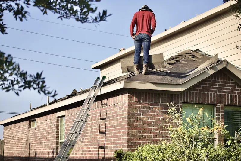 Professional roofer working on a residential roof in Downtown Newark